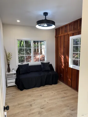 a bedroom with a bed window and a potted plant