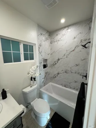 a bathroom with a sink toilet and shower