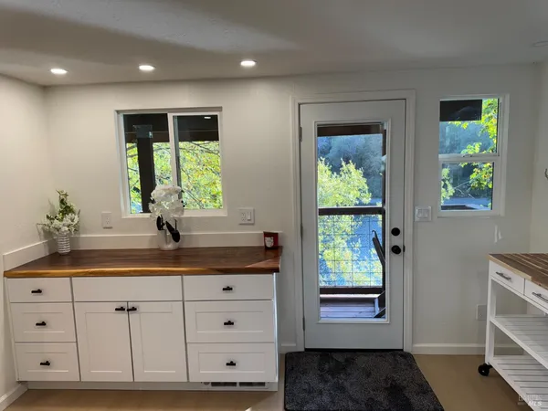 a bathroom with a granite countertop sink and a window