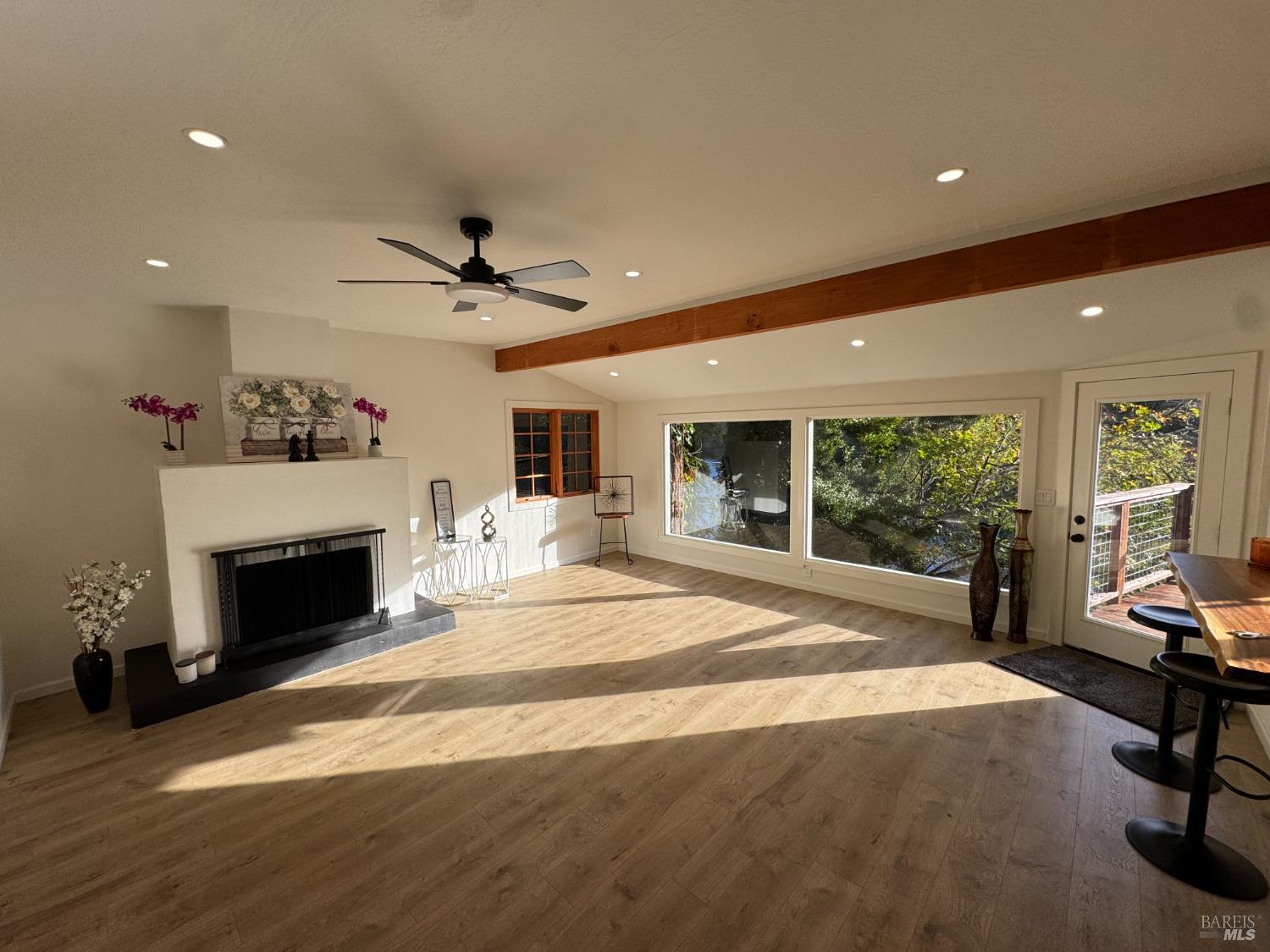 21883 Highway 116 Monte Rio, CA 95462 - Photo 7 of 28 a bed room with a fireplace and a ceiling fan