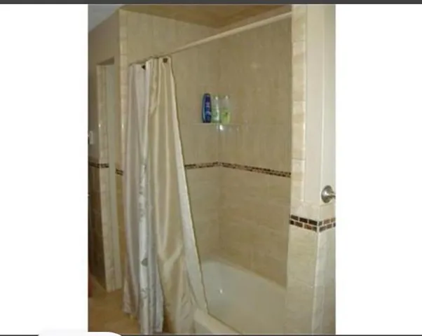 a bathroom with a glass shower door