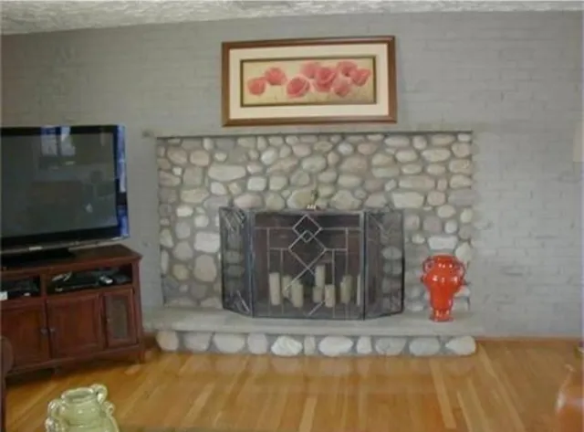 a room with a fireplace and a flat screen tv