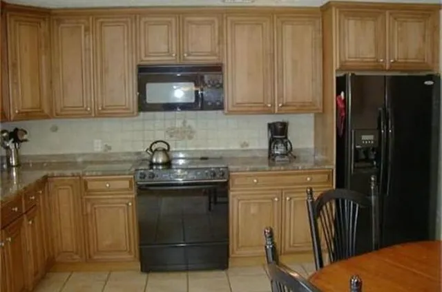 a kitchen with stainless steel appliances granite countertop a refrigerator sink and cabinets