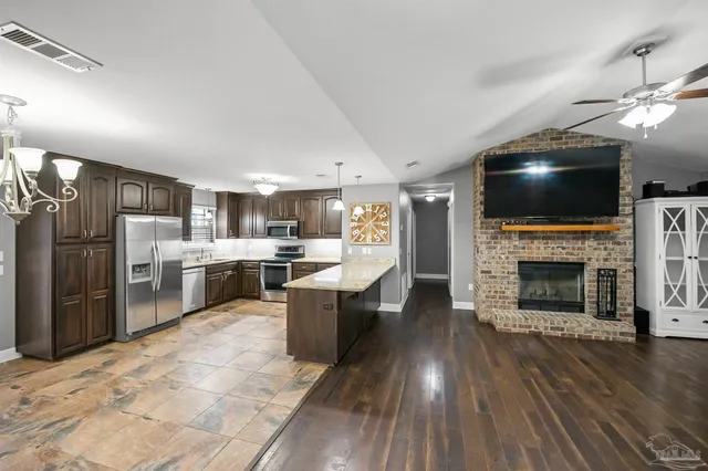a kitchen with granite countertop stainless steel appliances and wooden cabinets