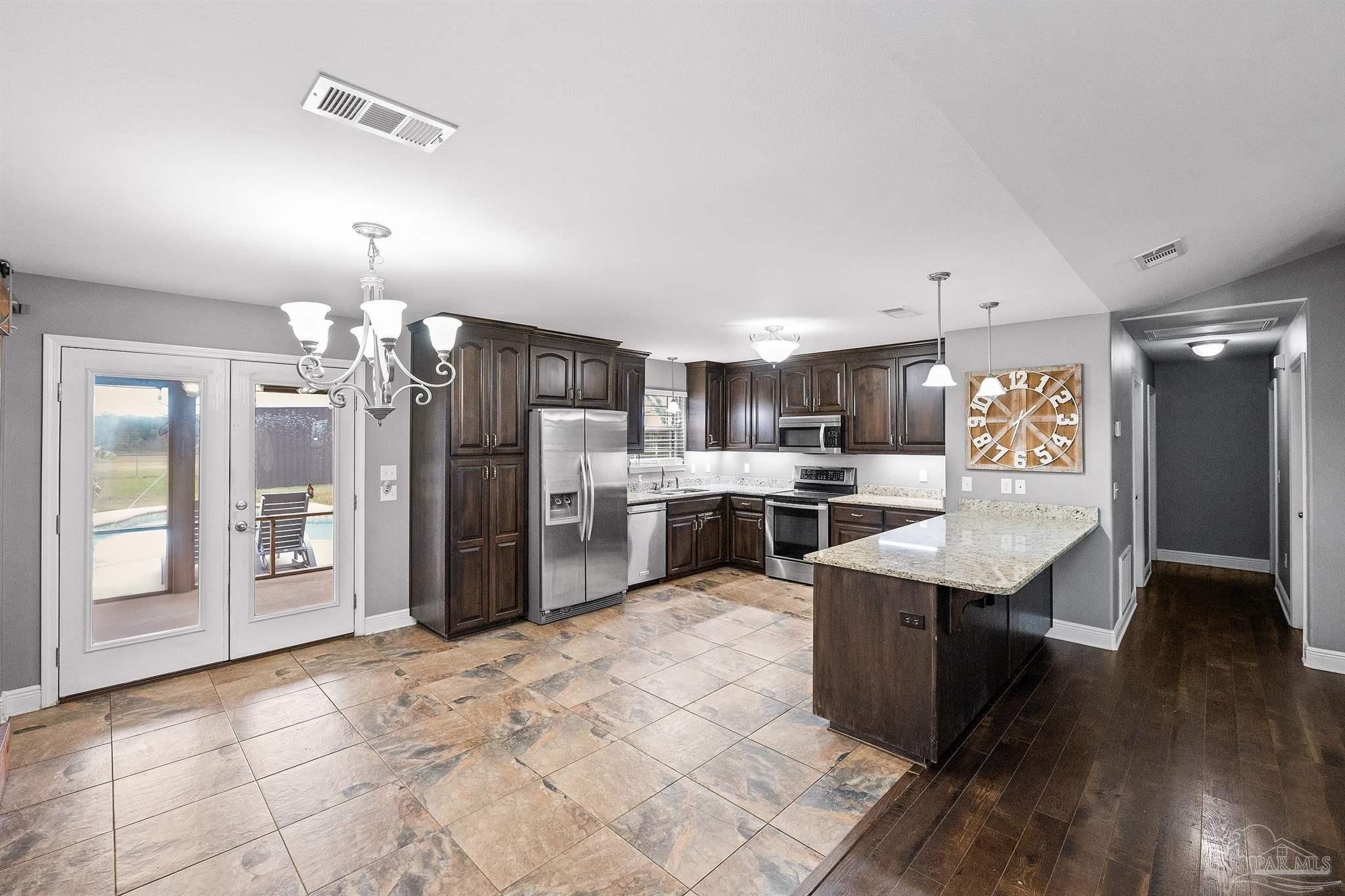 3500 Hazel Godwin Road Jay, FL 32565 - Photo 18 of 67 a kitchen with stainless steel appliances kitchen island granite countertop a refrigerator and a sink