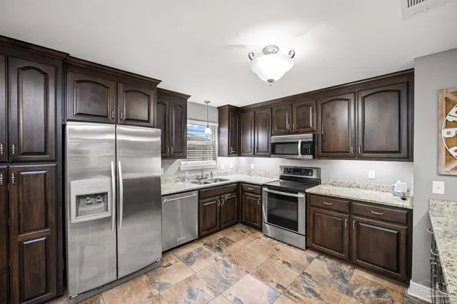 a view of an empty room with window and a ceiling fan