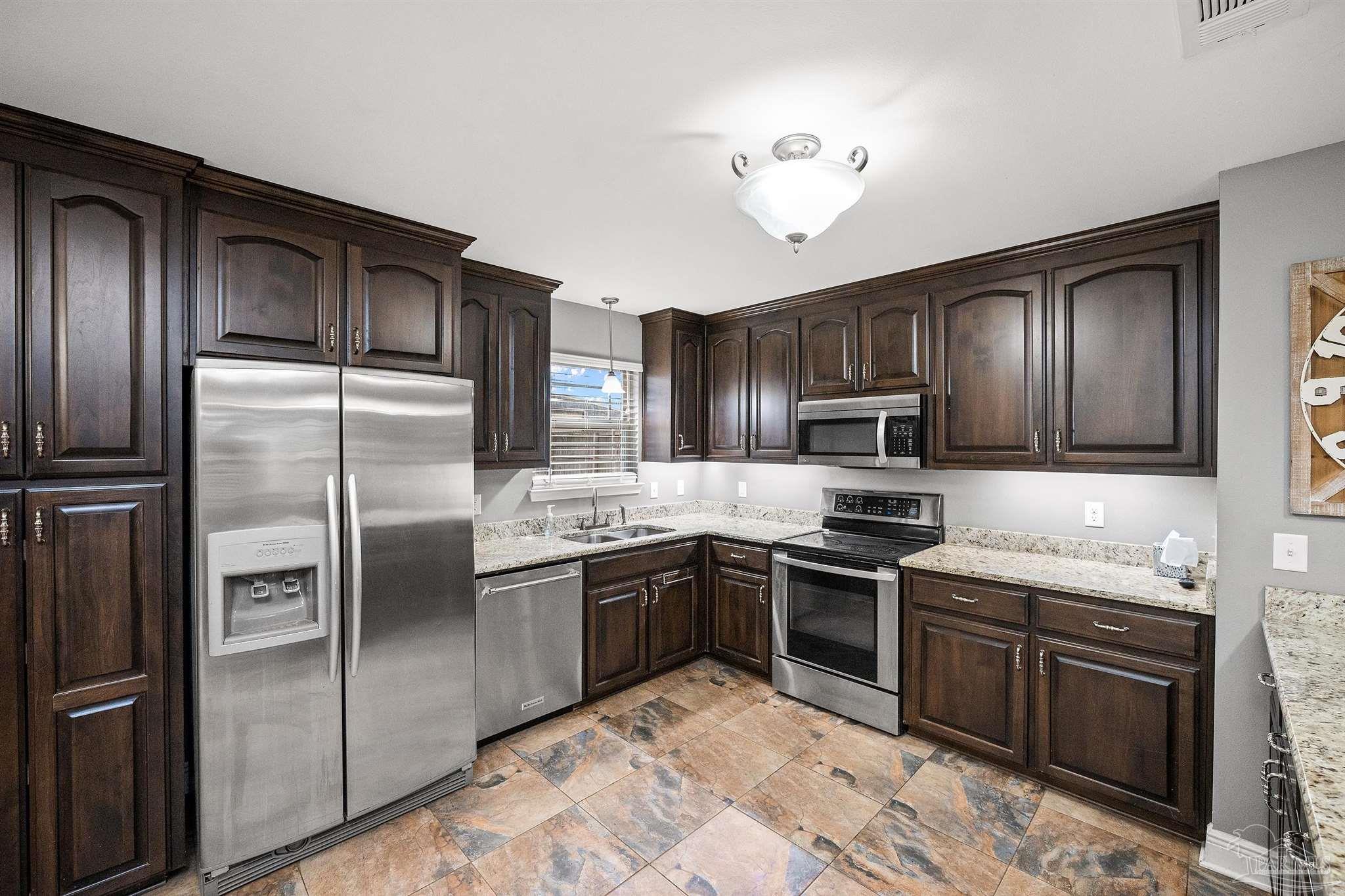 3500 Hazel Godwin Road Jay, FL 32565 - Photo 20 of 67 a kitchen with granite countertop stainless steel appliances and wooden cabinets