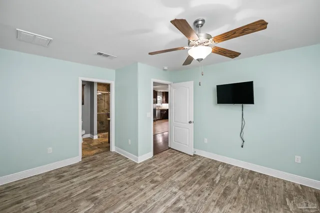 a bathroom with a granite countertop sink a toilet and a mirror
