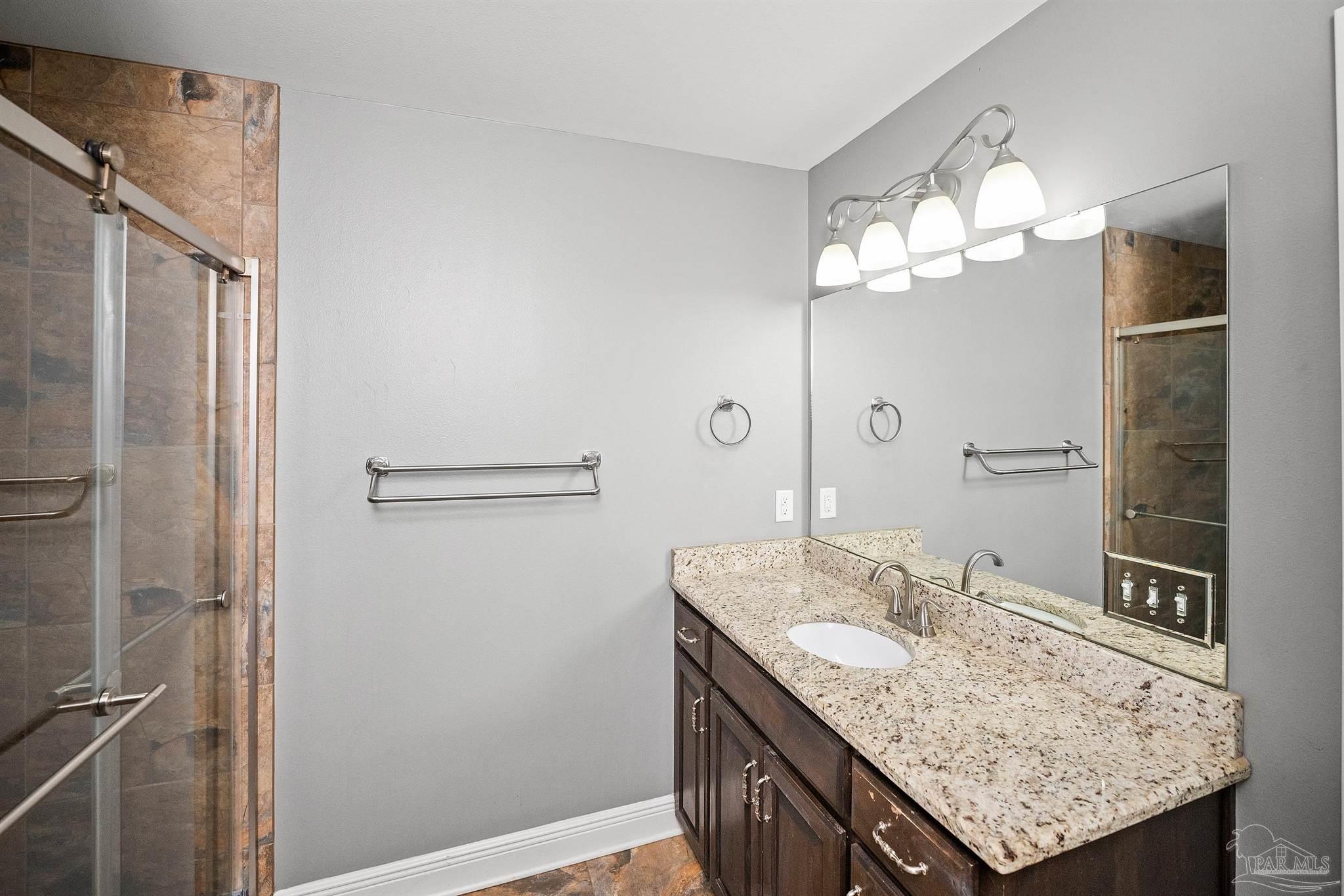 3500 Hazel Godwin Road Jay, FL 32565 - Photo 31 of 67 a bathroom with a granite countertop sink a toilet and a mirror
