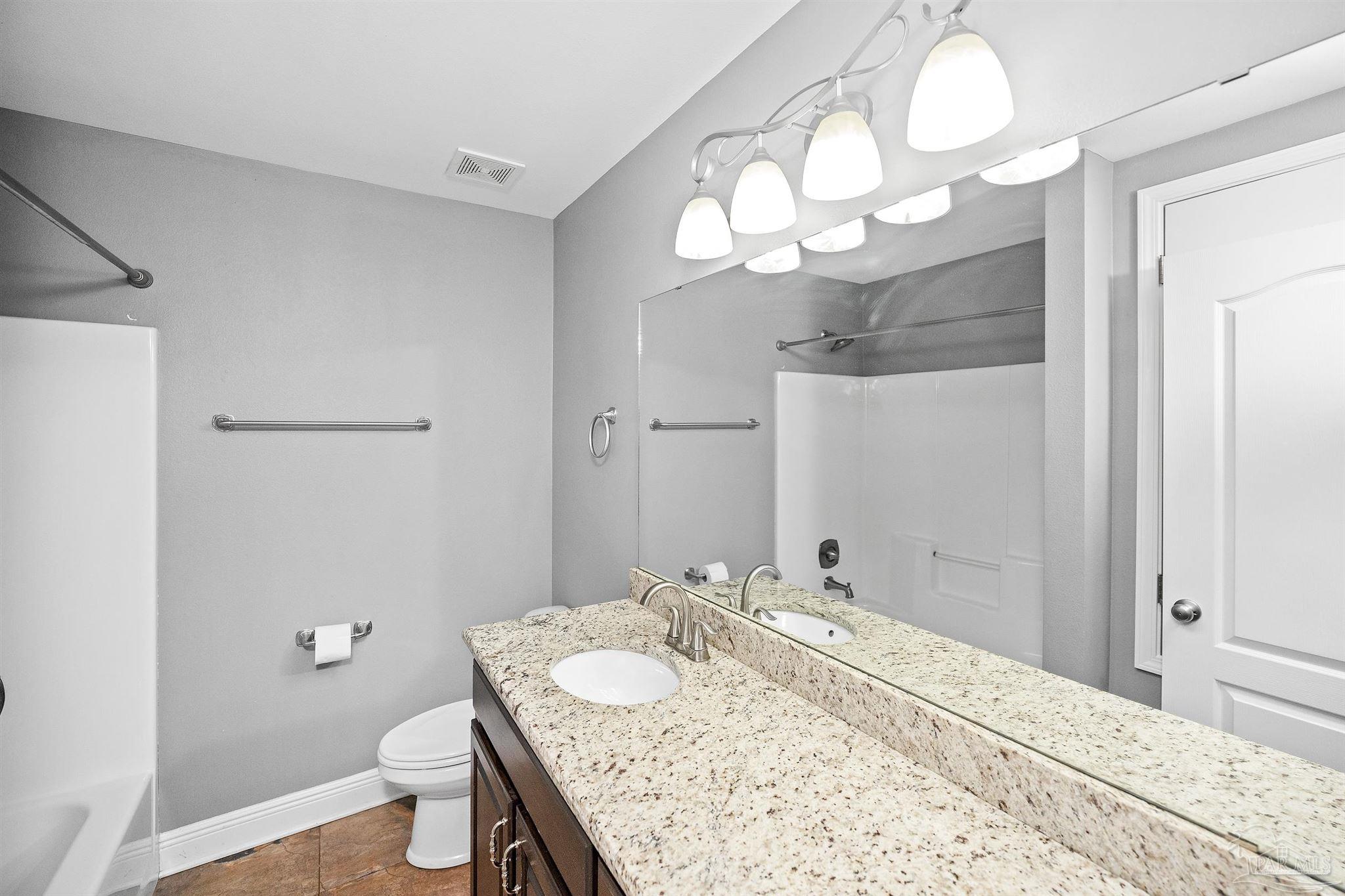 3500 Hazel Godwin Road Jay, FL 32565 - Photo 35 of 67 a bathroom with a granite countertop sink a toilet and a mirror