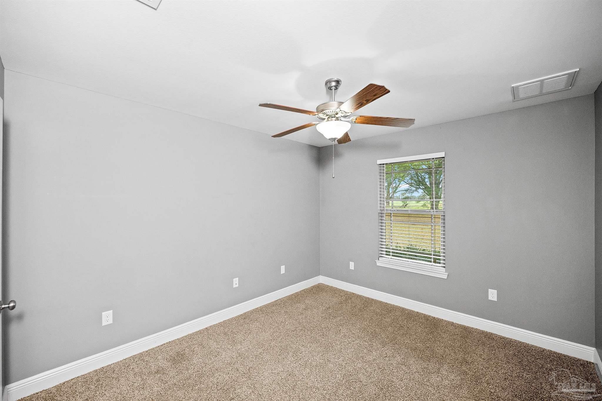 3500 Hazel Godwin Road Jay, FL 32565 - Photo 37 of 67 an empty room with a window and a fan