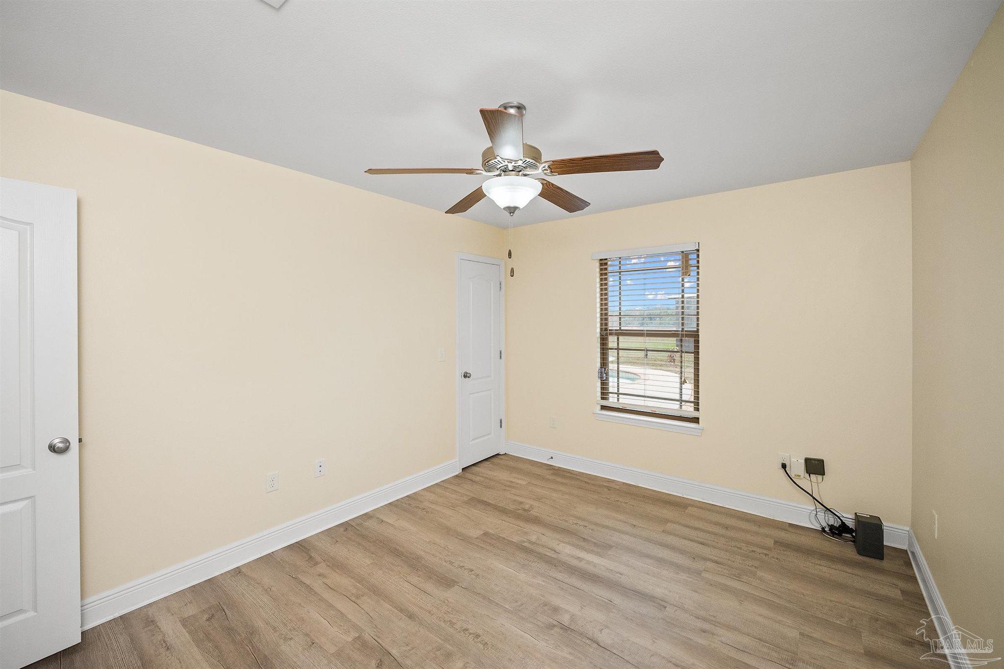 3500 Hazel Godwin Road Jay, FL 32565 - Photo 40 of 67 a view of empty room with wooden floor and fan