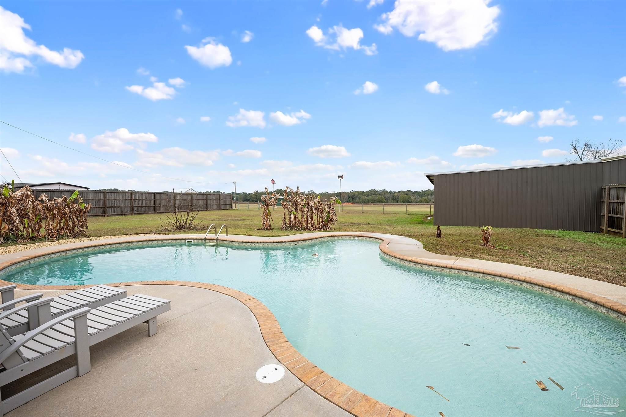 3500 Hazel Godwin Road Jay, FL 32565 - Photo 46 of 67 a view of a swimming pool and an outdoor seating