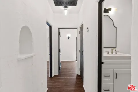 a view of a hallway with wooden floor and staircase