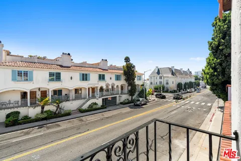 a view of a street with of cars parked on the roadside