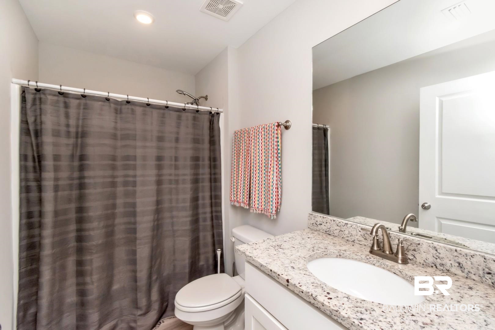 1295 Hayward Loop Foley, AL 36535 - Photo 20 of 29 Bathroom vanity featuring a speckled countertop and an undermount sink