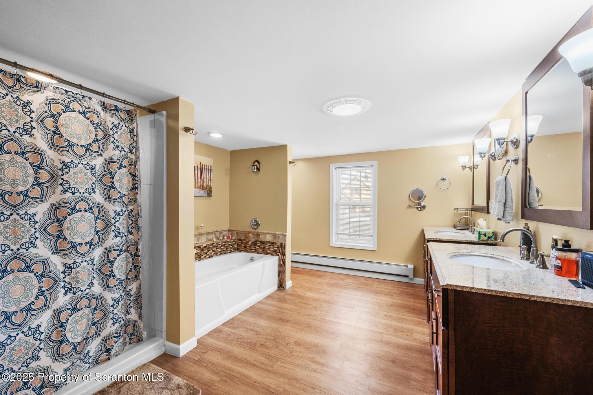 205 South Valley Avenue Olyphant, PA 18447 - Photo 14 of 44 a spacious bathroom with a tub sink and mirror