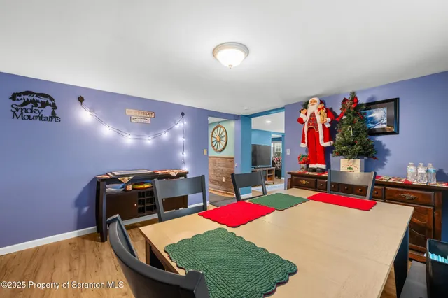 a living room with furniture pool table and rug