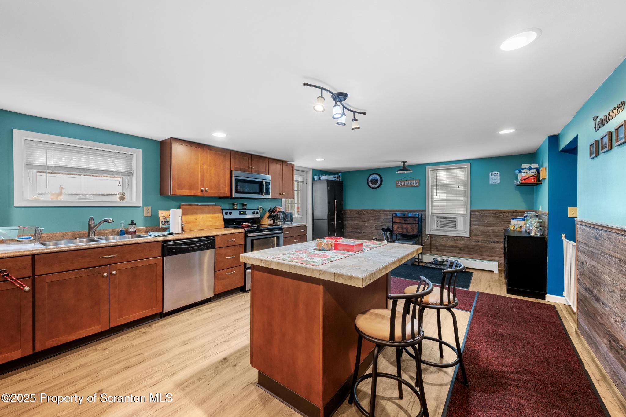 205 South Valley Avenue Olyphant, PA 18447 - Photo 23 of 44 a kitchen with stainless steel appliances granite countertop wooden cabinets a stove a sink and a refrigerator