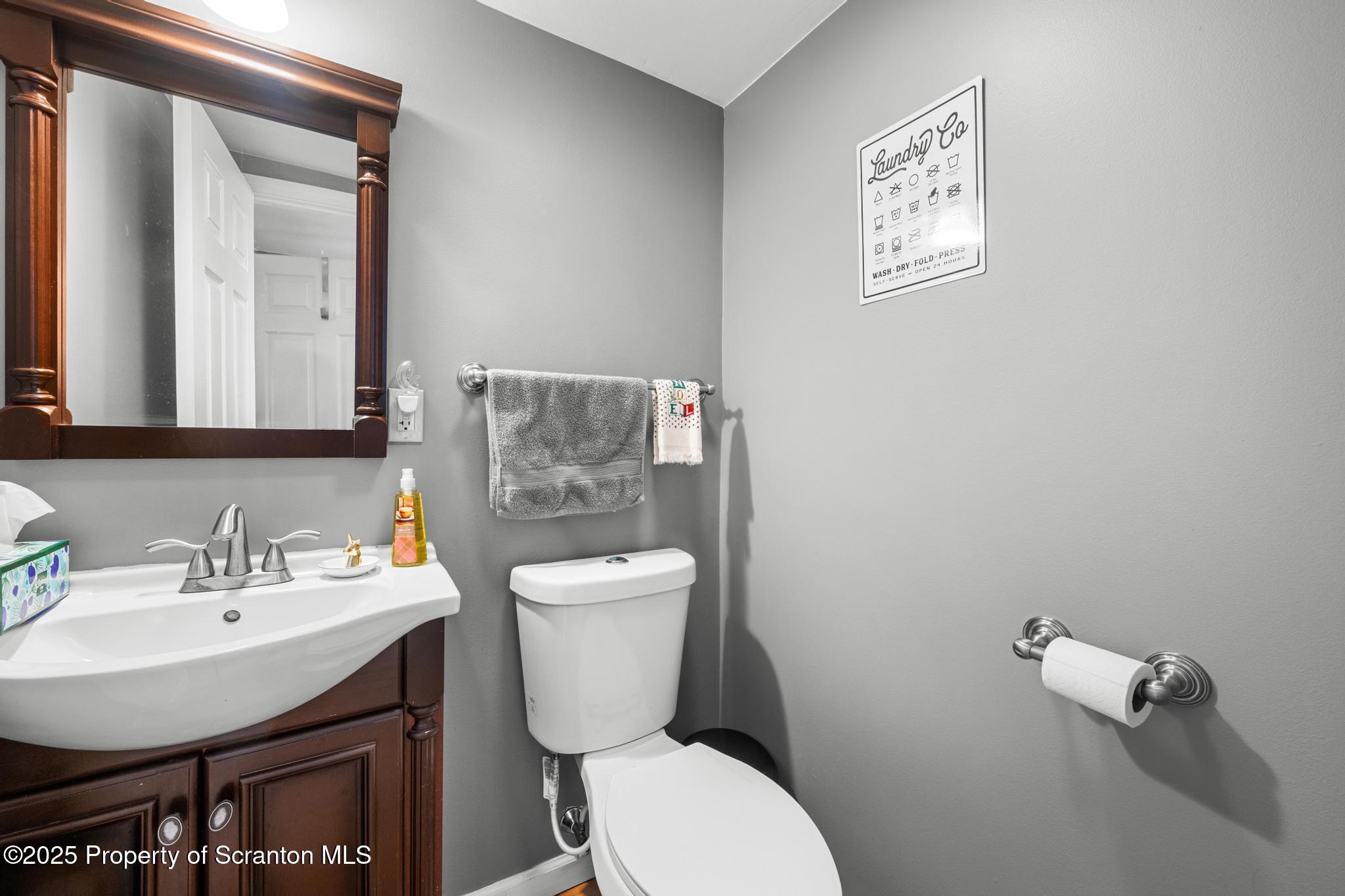 205 South Valley Avenue Olyphant, PA 18447 - Photo 3 of 44 a bathroom with a toilet a sink and mirror