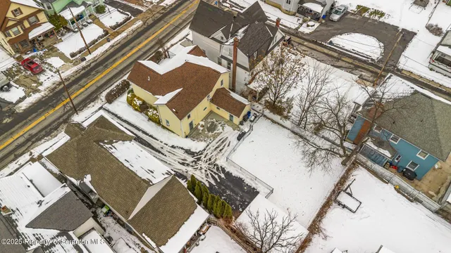 a view of a white house with a snow on the road