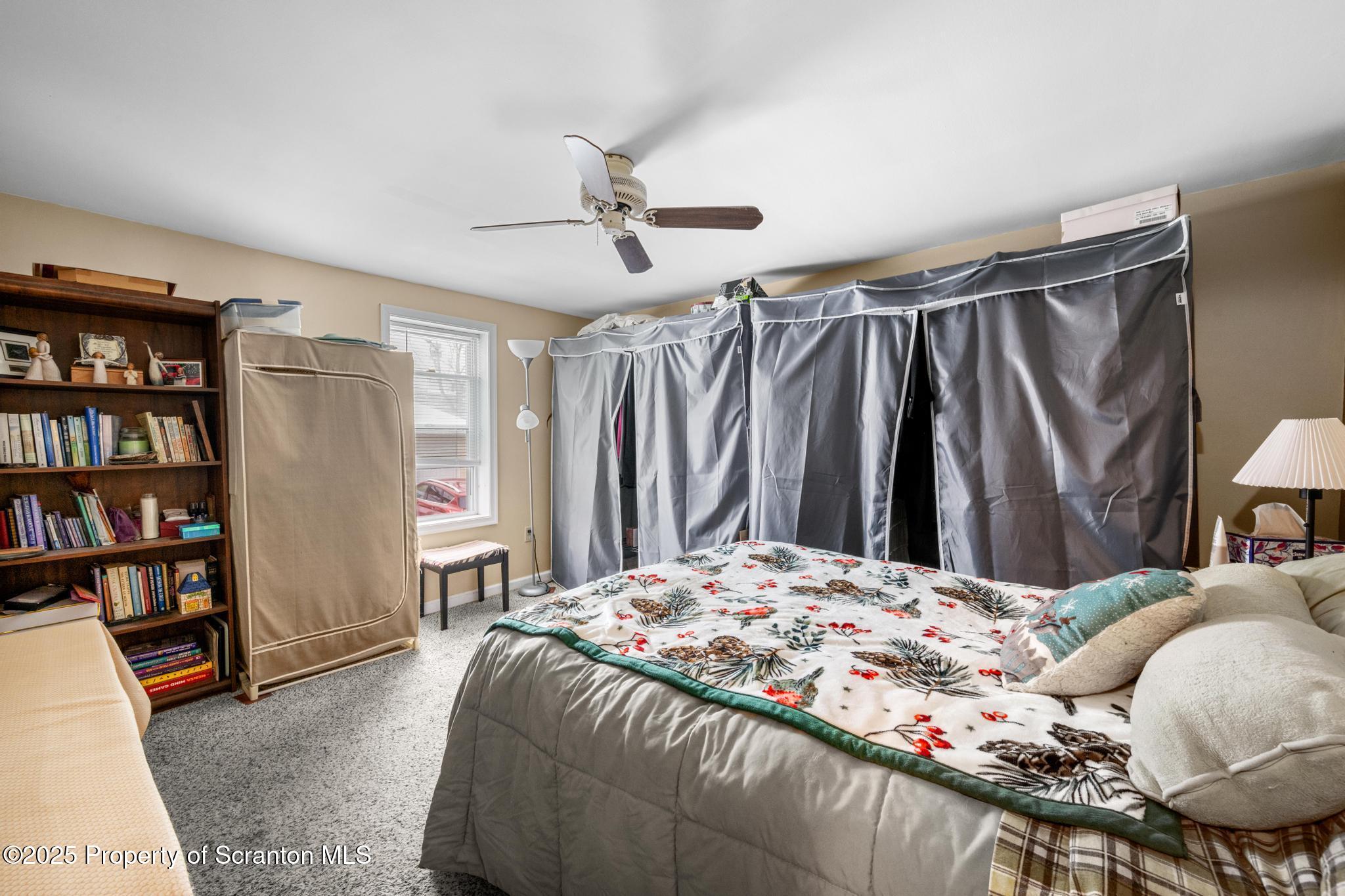 205 South Valley Avenue Olyphant, PA 18447 - Photo 8 of 44 a bedroom with a bed and a book shelf
