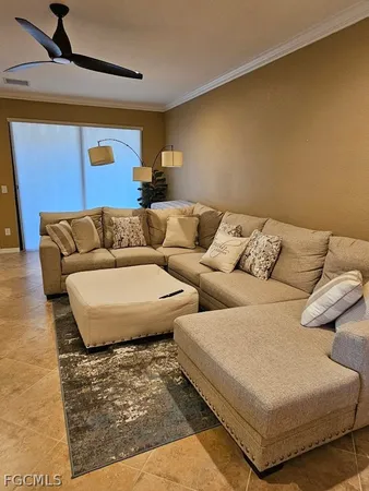 a living room with couches and painting on the wall