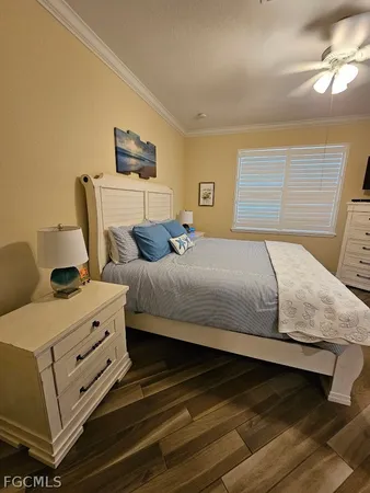 a bedroom with a bed and a ceiling fan