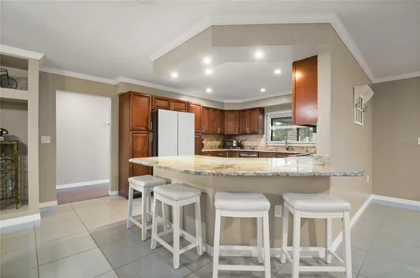 a kitchen with kitchen island granite countertop wooden cabinets and counter space