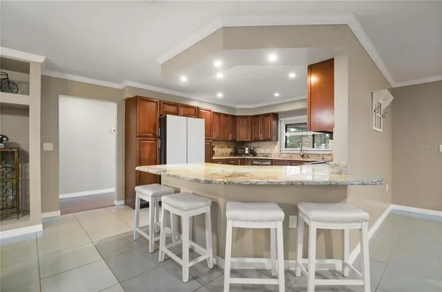 a kitchen with kitchen island granite countertop wooden cabinets and counter space