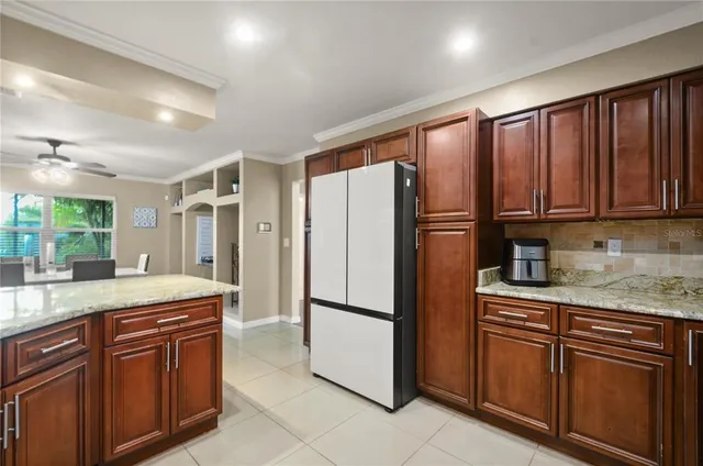 a kitchen with stainless steel appliances granite countertop a refrigerator and a sink
