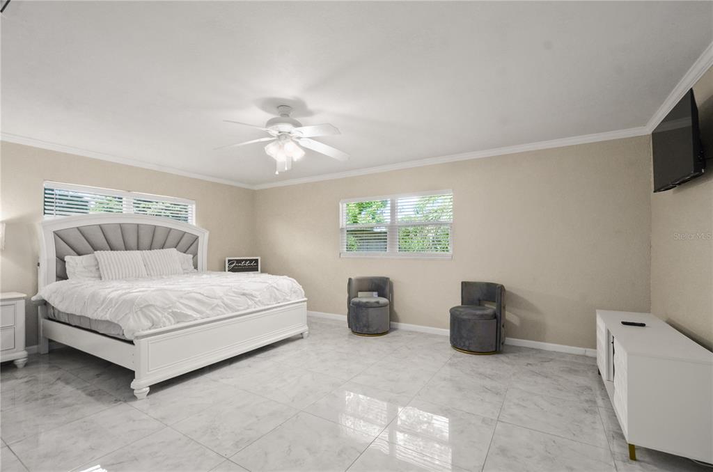 209 7th Street South Dundee, FL 33838 - Photo 17 of 36 a bedroom with a bed and a chandelier