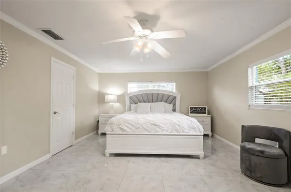 a spacious bedroom with a bed and window