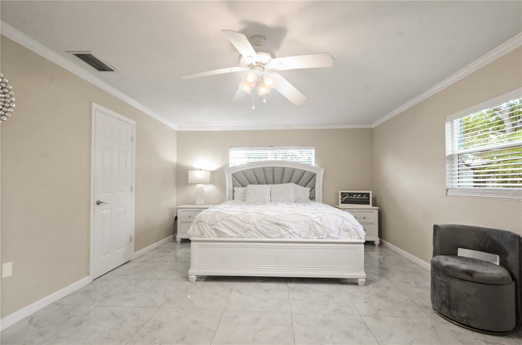 209 7th Street South Dundee, FL 33838 - Photo 18 of 36 a spacious bedroom with a bed and window