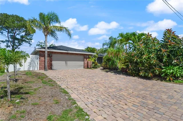 a front view of a house with a yard and a garage