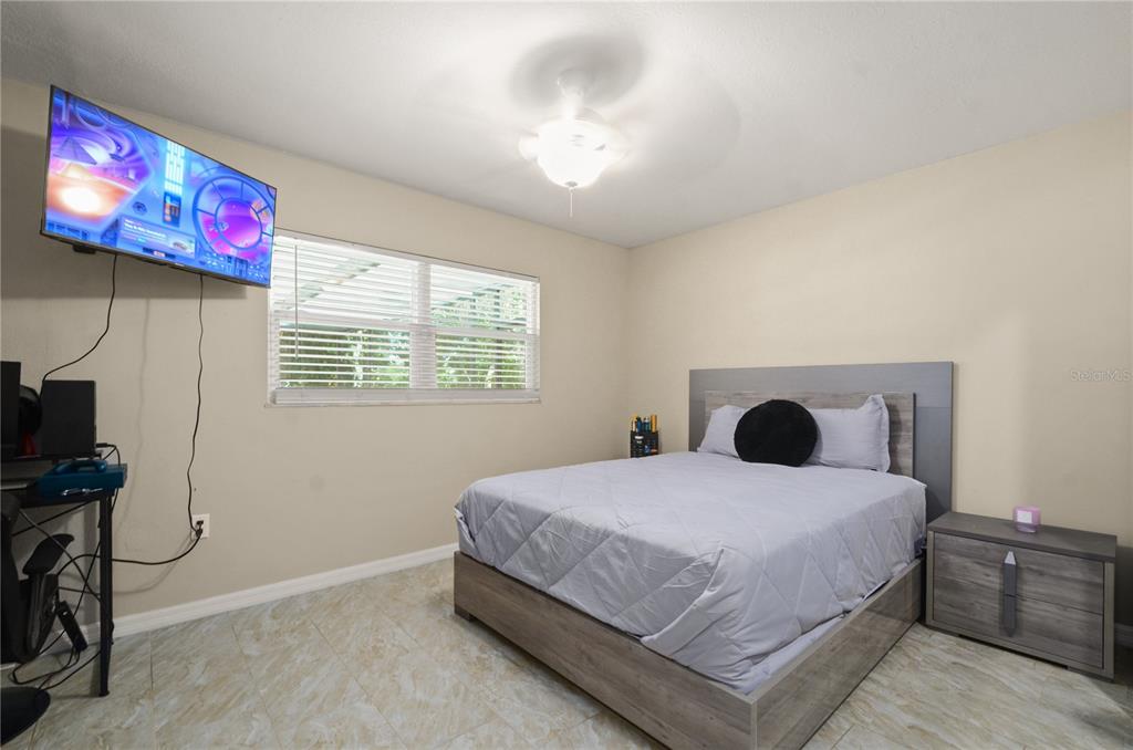 209 7th Street South Dundee, FL 33838 - Photo 22 of 36 a bedroom with a bed and a flat screen tv