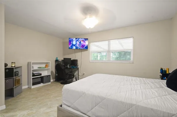 a bedroom with a bed and a flat screen tv