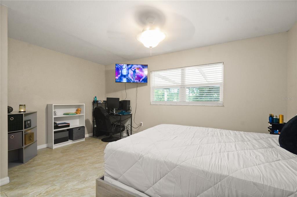 209 7th Street South Dundee, FL 33838 - Photo 23 of 36 a bedroom with a bed and a flat screen tv