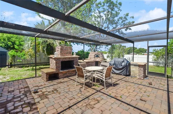 a view of a patio with a table chairs and a backyard