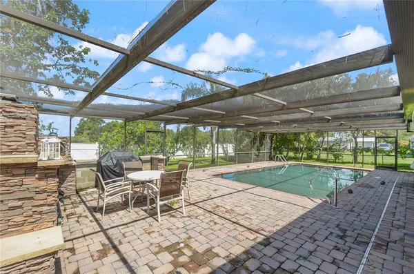 a view of a porch with chairs and backyard