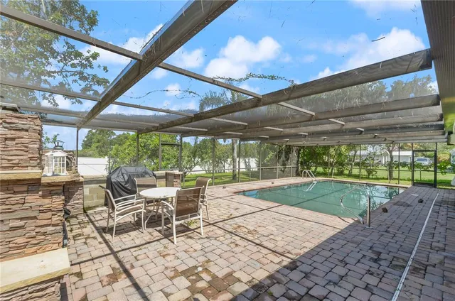 a view of a porch with chairs and backyard
