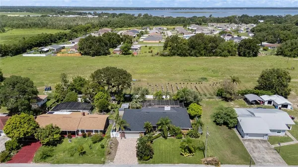 an aerial view of a houses with a yard