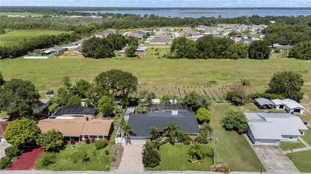 an aerial view of a houses with a yard