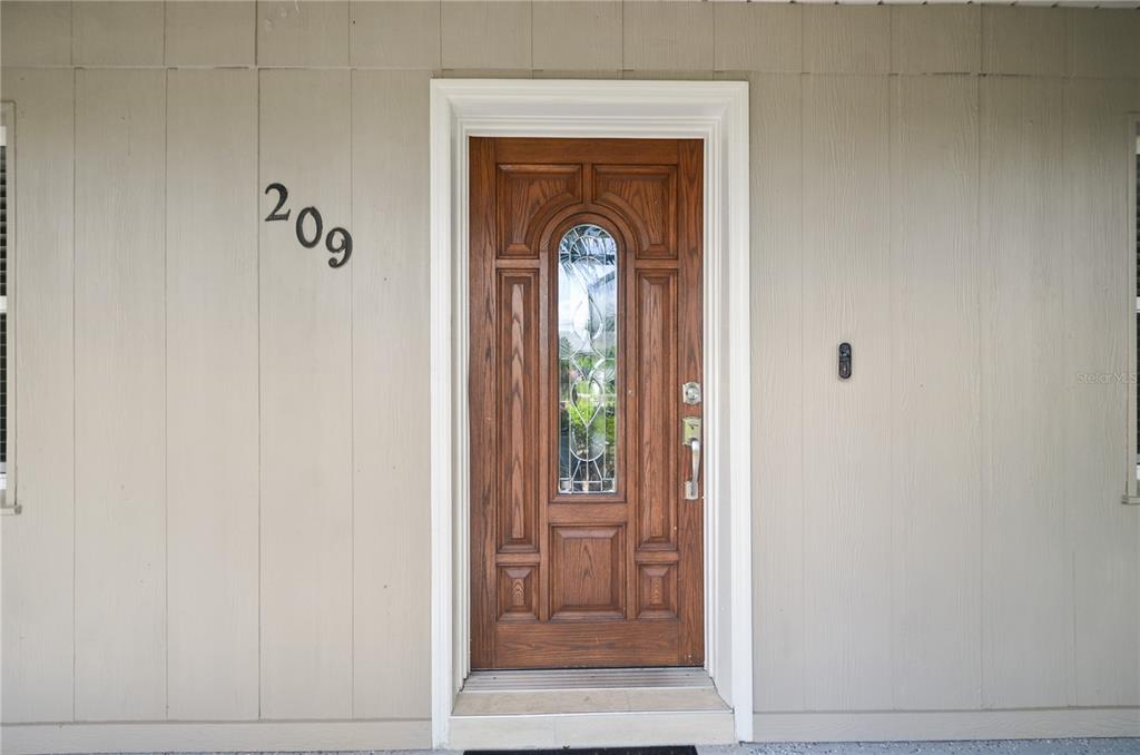 209 7th Street South Dundee, FL 33838 - Photo 4 of 36 a front view of a entryway door with a mirror