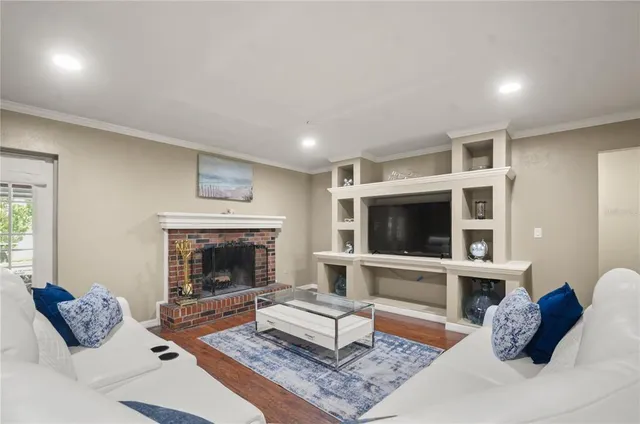 a living room with furniture fireplace and flat screen tv