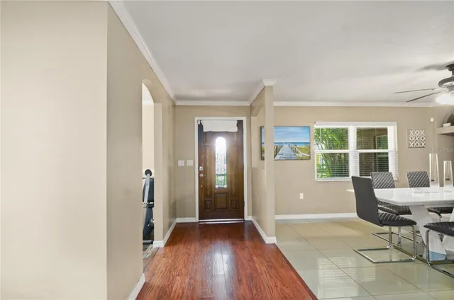 a view of a livingroom with wooden floor and furniture