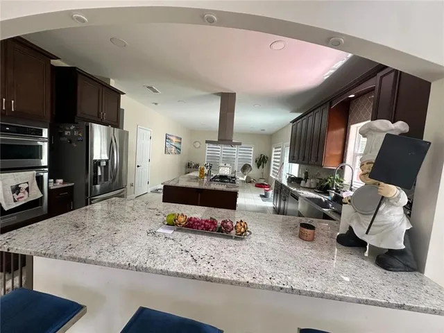 a living room with furniture and a kitchen area