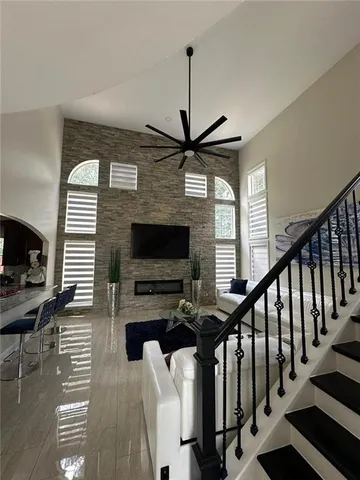 a living room with fireplace furniture and a flat screen tv