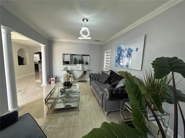 a living room with a couch and a chandelier