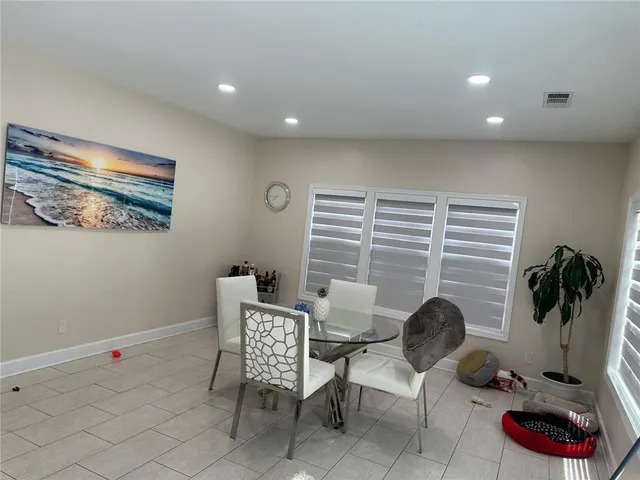 a livingroom with furniture and a potted plant